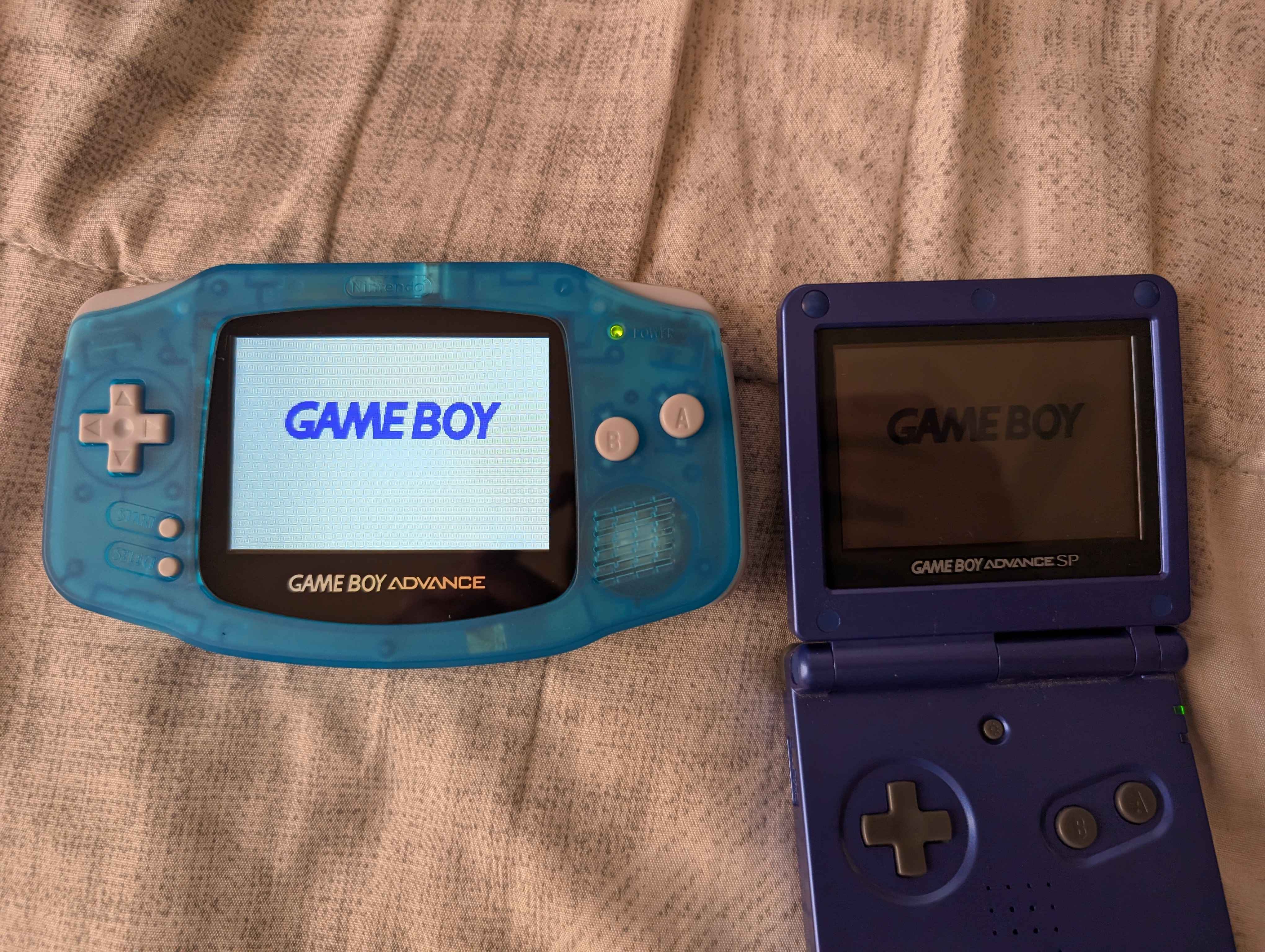 Picture of the modded Gameboy Advance [left] next to an unmodded Gameboy Advance SP with the backlight off.